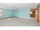 Living room with light blue walls and access to kitchen at 6 Seminole Dr, Bradenton, FL 34208