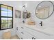 Elegant bathroom with double vanity, quartz countertop, and large mirror at 6418 Margarita Shores Ln, Apollo Beach, FL 33572
