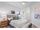 Bright bedroom with a queen-size bed and wood floors at 6418 Margarita Shores Ln, Apollo Beach, FL 33572