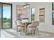 Bright dining room features a large wooden table and six chairs, with access to a balcony at 6418 Margarita Shores Ln, Apollo Beach, FL 33572