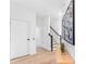 Bright and spacious entryway with wood floors and modern staircase at 6418 Margarita Shores Ln, Apollo Beach, FL 33572