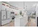 Modern kitchen with white cabinets, quartz countertops, and stainless steel appliances at 6418 Margarita Shores Ln, Apollo Beach, FL 33572