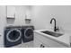 Convenient laundry room with washer, dryer, and utility sink at 6418 Margarita Shores Ln, Apollo Beach, FL 33572