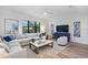 Relaxing living room with sectional sofa, coffee table, and large windows at 6418 Margarita Shores Ln, Apollo Beach, FL 33572