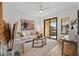 Bright living room with modern furniture and sliding glass doors leading to a balcony at 6418 Margarita Shores Ln, Apollo Beach, FL 33572