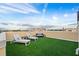 Relaxing rooftop terrace with artificial turf, lounge chairs, and city views at 6418 Margarita Shores Ln, Apollo Beach, FL 33572
