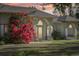 House exterior at sunset, featuring vibrant bougainvillea at 6488 Ponce De Leon Blvd, North Port, FL 34291