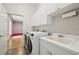 Bright laundry room with washer, dryer, and utility sink at 6488 Ponce De Leon Blvd, North Port, FL 34291