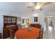 Bright dining room with round table, wood hutch, and view into kitchen at 6706 16Th E Ave, Palmetto, FL 34221