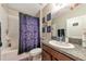Bathroom with shower/tub combo, granite vanity, and Halloween-themed decor at 7404 Mill Hopper Ct, Palmetto, FL 34221