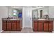 Bathroom with double vanity, granite countertop, wood cabinets, and tile flooring at 7404 Mill Hopper Ct, Palmetto, FL 34221