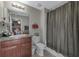 Bathroom with granite vanity, shower/tub, toilet, and tile flooring at 7404 Mill Hopper Ct, Palmetto, FL 34221