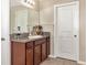 Bathroom featuring single vanity, granite countertop, wood cabinets, tile flooring and neutral walls at 7404 Mill Hopper Ct, Palmetto, FL 34221