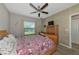 Bedroom with a queen bed, ceiling fan, and wood flooring at 7404 Mill Hopper Ct, Palmetto, FL 34221