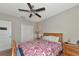 Bedroom with ceiling fan, closet, and a window for natural light at 7404 Mill Hopper Ct, Palmetto, FL 34221