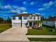 Two-story house with a two-car garage and landscaped yard at 7404 Mill Hopper Ct, Palmetto, FL 34221