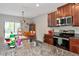 Kitchen with stainless appliances, dark wood cabinetry, and granite counters at 7404 Mill Hopper Ct, Palmetto, FL 34221