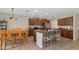 Open kitchen features granite counters, stainless appliances, tiled floor, and a dining area at 7404 Mill Hopper Ct, Palmetto, FL 34221