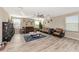 Cozy living room with hardwood floors, natural light, and comfortable seating decorated for the Christmas holiday at 7404 Mill Hopper Ct, Palmetto, FL 34221