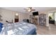 Main bedroom featuring a full bed, ensuite bathroom, ample storage, and neutral walls at 7404 Mill Hopper Ct, Palmetto, FL 34221