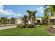 Two-story house with a well-manicured lawn and palm trees in a residential area at 7616 Alumni Trl, Sarasota, FL 34243