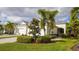 Well-maintained house with a landscaped front yard and palm trees at 7616 Alumni Trl, Sarasota, FL 34243