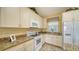 Kitchen features granite countertops and white appliances at 7616 Alumni Trl, Sarasota, FL 34243