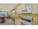 Kitchen boasts granite countertops and white appliances at 7616 Alumni Trl, Sarasota, FL 34243