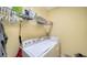 Laundry room with washer, dryer, and shelving at 7616 Alumni Trl, Sarasota, FL 34243