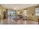 Living room with comfortable seating, large windows, and access to a patio at 7616 Alumni Trl, Sarasota, FL 34243