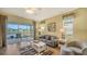 Living room with a view of the water, comfortable seating, and large windows at 7616 Alumni Trl, Sarasota, FL 34243