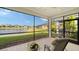 Relaxing screened porch overlooking a lake with view of other homes at 7616 Alumni Trl, Sarasota, FL 34243