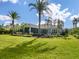 Spacious backyard with tropical landscaping, pool, and screened patio at 8325 Lindrick Ln, Bradenton, FL 34202
