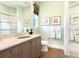 Light and airy bathroom with a double vanity and shower at 8325 Lindrick Ln, Bradenton, FL 34202