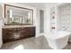 Elegant bathroom with soaking tub, double vanity, and large mirror at 8325 Lindrick Ln, Bradenton, FL 34202