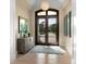 Bright and airy foyer with hardwood floors, a large rug, and double doors at 8325 Lindrick Ln, Bradenton, FL 34202