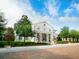 Grand white home with columns and manicured landscaping at 8325 Lindrick Ln, Bradenton, FL 34202