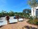Brick paved patio area with golf cart and potted plants at 8325 Lindrick Ln, Bradenton, FL 34202