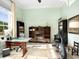 Home office with built-in shelving, large window, and exercise bike at 8325 Lindrick Ln, Bradenton, FL 34202