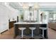 Modern kitchen with island, white cabinets, and breakfast bar seating at 8325 Lindrick Ln, Bradenton, FL 34202