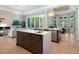 Open kitchen with island, stainless steel appliances, and hardwood floors at 8325 Lindrick Ln, Bradenton, FL 34202