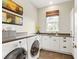 Laundry room with modern washer, dryer, and ample counter space at 8325 Lindrick Ln, Bradenton, FL 34202