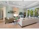 Open living space with a stone fireplace, large windows and hardwood floors at 8325 Lindrick Ln, Bradenton, FL 34202