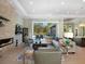 Spacious living area with a stone fireplace, large sectional sofa, and hardwood floors at 8325 Lindrick Ln, Bradenton, FL 34202