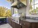 Luxury outdoor kitchen featuring stainless steel grill and granite countertops at 8325 Lindrick Ln, Bradenton, FL 34202