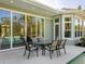 Relaxing patio with glass-top table and chairs near the pool at 8325 Lindrick Ln, Bradenton, FL 34202
