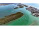 Stunning aerial view of waterfront homes and boats on the bay, offering picturesque coastal living at 8472 Gateway Ct, Englewood, FL 34224