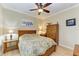 Guest bedroom with queen bed, wooden dresser, and ceiling fan at 1230 Collier Pl, Venice, FL 34293