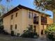 Tan building exterior with balcony and landscaping at 1111 Faith W Cir # 2003, Bradenton, FL 34212