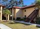 Building exterior showing a walkway, landscaping, and stairs at 1111 Faith W Cir # 2003, Bradenton, FL 34212